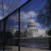 Capitol building behind a fence