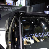 A promoter stands near the all-electric Volvo XC40 during the Shanghai Auto Show.