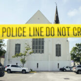 Police tape surrounds the parking lot behind the AME Emanuel Church.