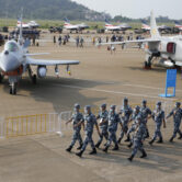 Chinese Air Force personnel march past Chinese military planes.
