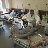 A nurse covers a Covid-19 patient with a blanket at an ICU in Ukraine.