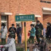 Masked residents lined up to receive Covid-19 vaccine booster shots in Beijing.