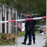Forensic experts search for evidence in the area where a Dutch lawyer who was gunned down.