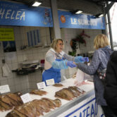 People buy fish at the market of the port of Boulogne-sur-Mer, northern France.