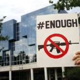 A protester holds a sign outside the NRA's headquarters in Virginia.