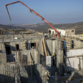 Palestinian laborers work building new houses in the West Bank Jewish settlement of Bruchin.