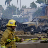 Fire crews work the scene of a plane crash in Santee, Calif.