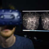 A software engineer explores with a virtual reality helmet the most detailed 3D map of the universe.
