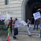 Protesters picket outside LA City Hall.