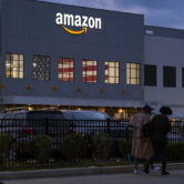 People arrive for work at an Amazon distribution center.