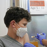 A child gets the first shot of the Pfizer Covid-19 vaccine.