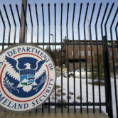 A Homeland Security Department headquarters sign is pictured.