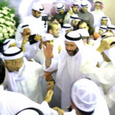 Faisal al-Muslim waves to supporters at a celebration marking his return to Kuwait.