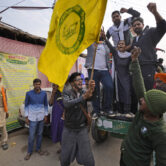 Indian farmers shout slogans as they celebrate news of the repeal of farm laws.
