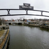 This photo shows a sign over the Flint River in Flint, Mich.