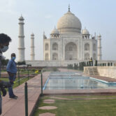 A man disinfects the premises of the Taj Mahal.