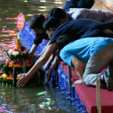 Thais place a krathong during the Loy Krathong festival in Bangkok, Thailand.