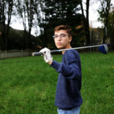 Transgender teen Luc Esquivel holds a golf club