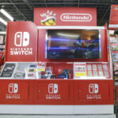 A man walks past a display for the Nintendo Switch.