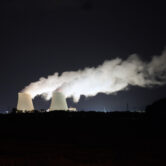 Steam escapes at night from the nuclear plant in France.