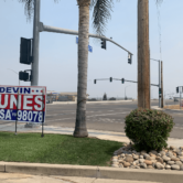 Campaign signs for Devin Nunes sit on all four corners of an intersection in Tulare.