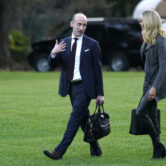 Kayleigh McEnany and Stephen Miller walk across the South Lawn of the White House.