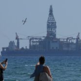 People take photos of the 'Tungsten Explored' drilling ship in Cyprus.