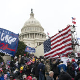 Violent insurrectionists stand outside the U.S. Capitol on Jan. 6, 2021.