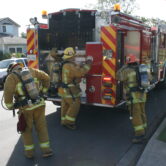 Los Angeles firefighters putting on their gear.