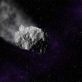 A computer generated asteroid flying through space.