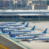 China Southern Airlines Boeing 737 Max airplanes are parked at the edge of a tarmac.