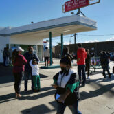 People line up for a free Covid-19 rapid test at a gas station in Los Angeles.