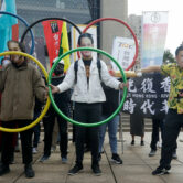 Human rights groups gather to protest the Beijing Winter Olympics 2022.
