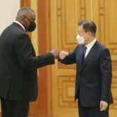 Moon Jae-in bumps elbows with Lloyd Austin before their meeting in Seoul.