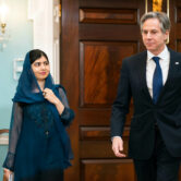 Malala Yousafzai and Antony Blinken walk to the Treaty Room at the State Department.