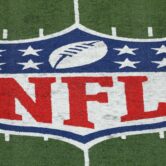 NFL logo painted on a football field.