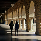 Students walk on the Stanford University campus in Stanford, Calif.