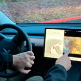 A Tesla owner shows how he can play video games on the vehicle's console while driving.