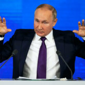 Vladimir Putin gestures while speaking during his annual news conference in Moscow.