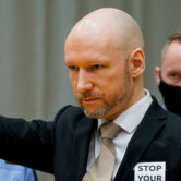 Anders Behring Breivik arrives in court on the first day of a hearing where he is seeking parole.