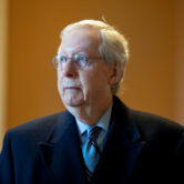 Mitch McConnell speaks to a reporter at the Capitol in Washington.