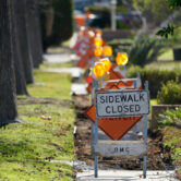 A sidewalk is closed as crews work on repairs in Upland, Calif.