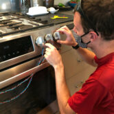 A researcher attaches sensors to a stove.