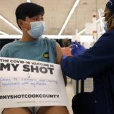 A teenage boy receives a Covid-19 vaccine shot in Illinois.