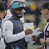 Brian Flores speaking to an NFL official during a game against the New Orleans Saints.