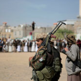 Armed Houthi fighters attend the funeral procession of fellow rebels.