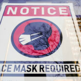 A sign requiring masks is posted on a storefront in Philadelphia.