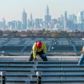 Electricians install solar panels in New York.