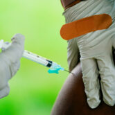 A health worker administers a dose of a Pfizer Covid-19 vaccine.