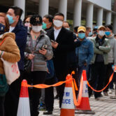 Residents line up to get tested for Covid-19 at a temporary testing center in Hong Kong.